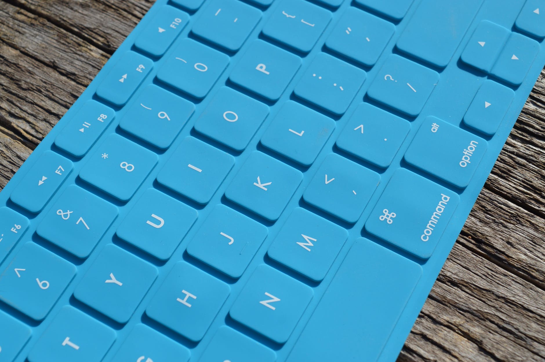 blue computer keyboard on gray wooden surface