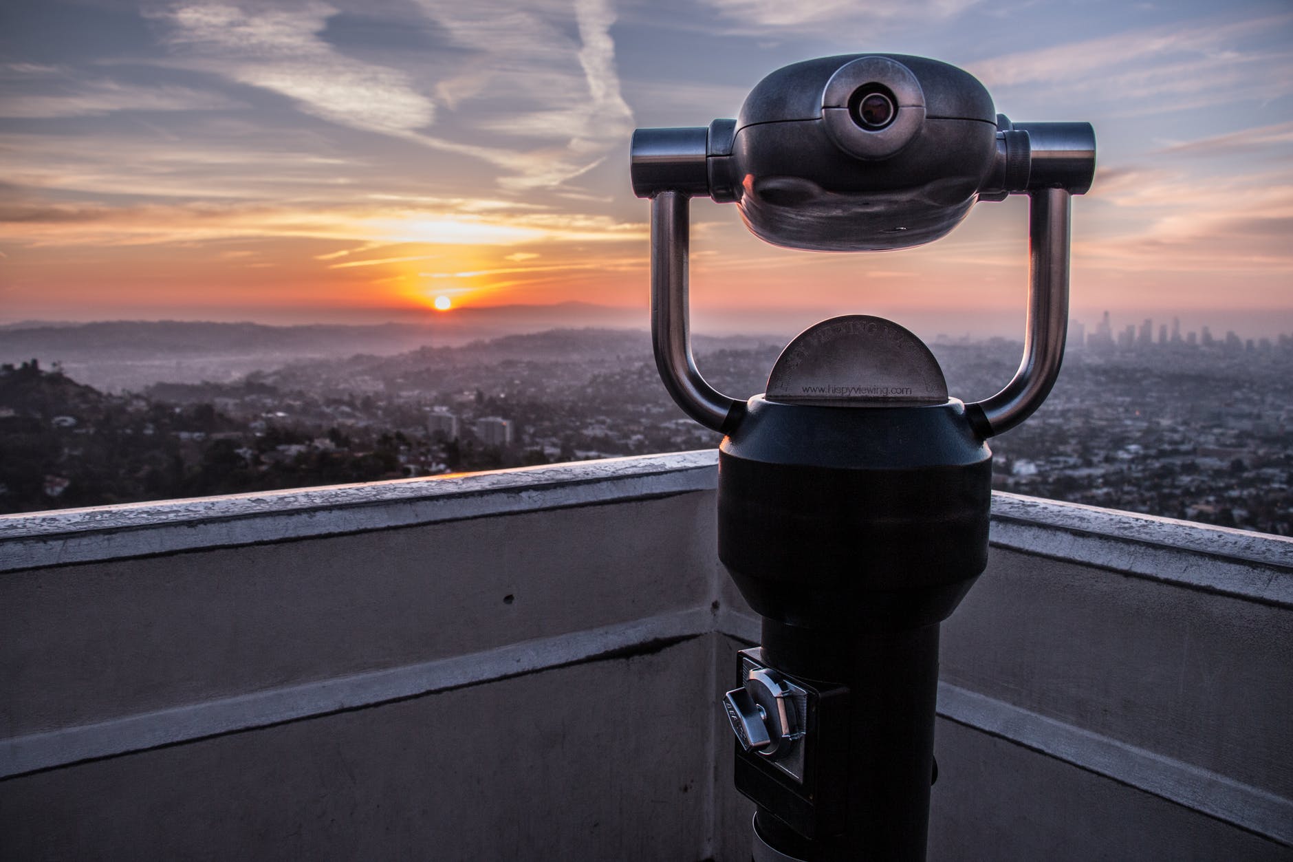 coin operated tower viewer on rooftop during sunset